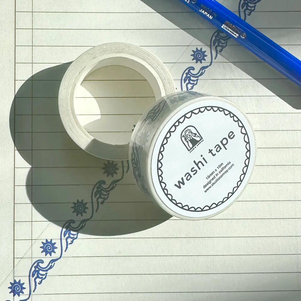Two rolls of washi tape on a lined paper background