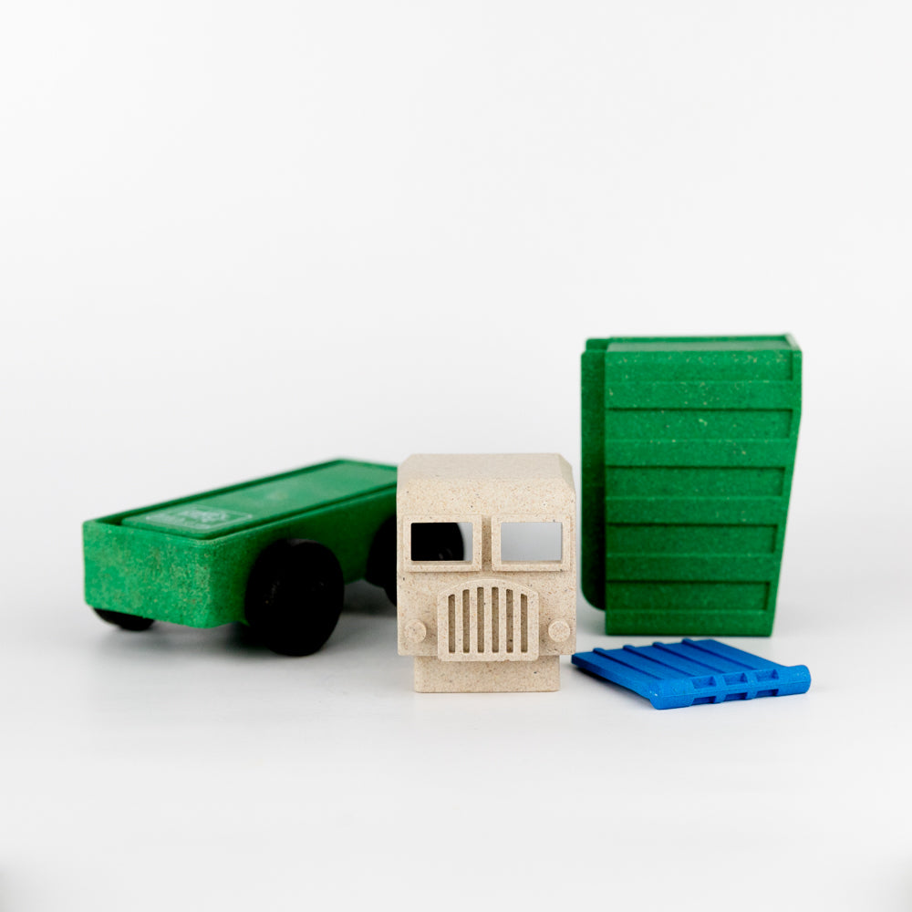 Toy truck with a wooden face and additional toy parts on a white background