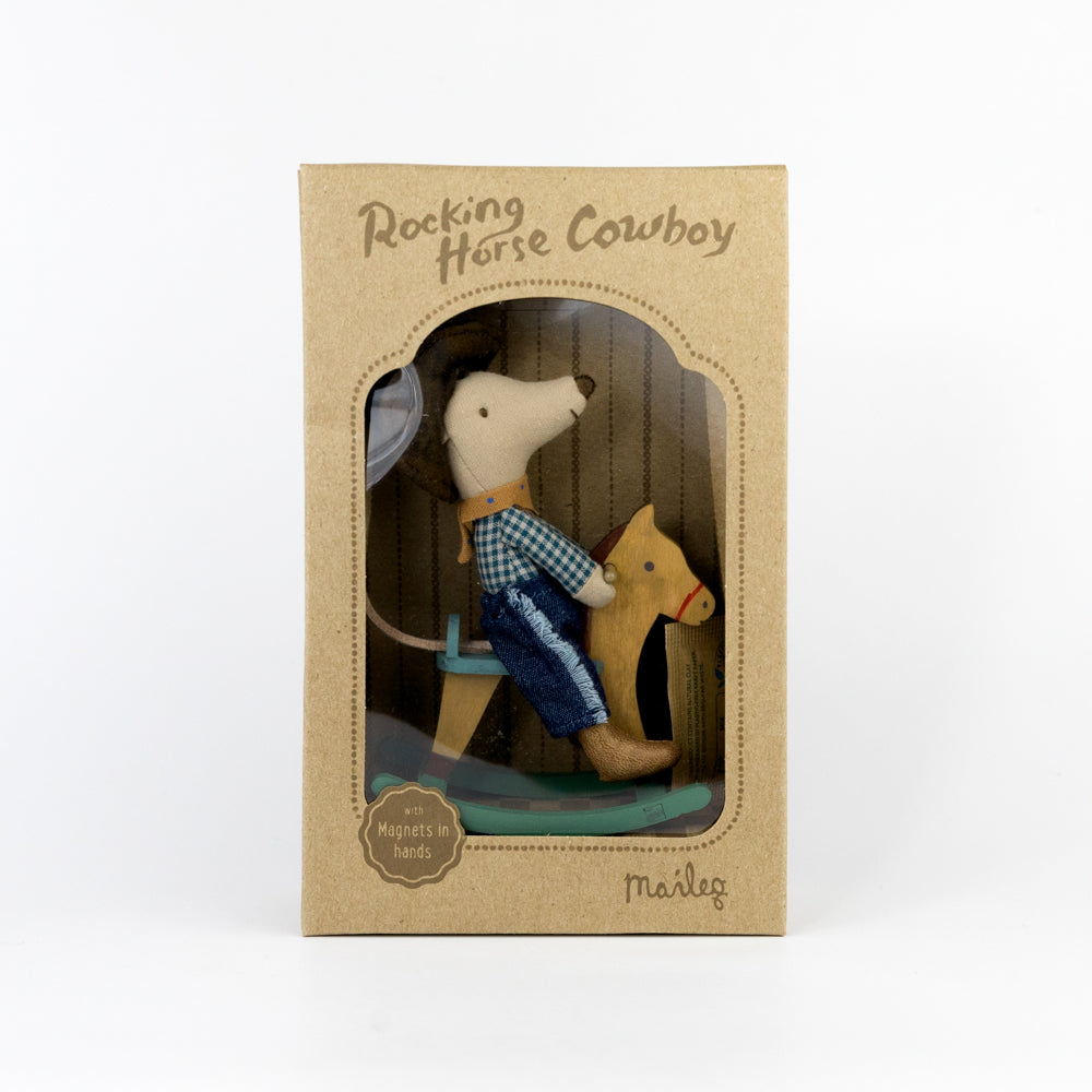 Toy mouse in a cowboy outfit riding a rocking horse on a white background