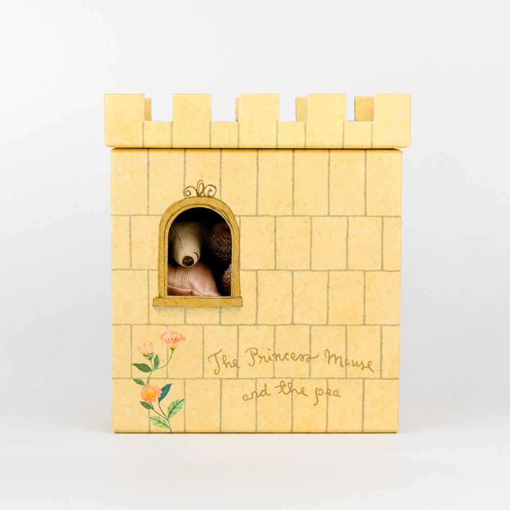 Wooden castle toy with a small mouse inside on a white background