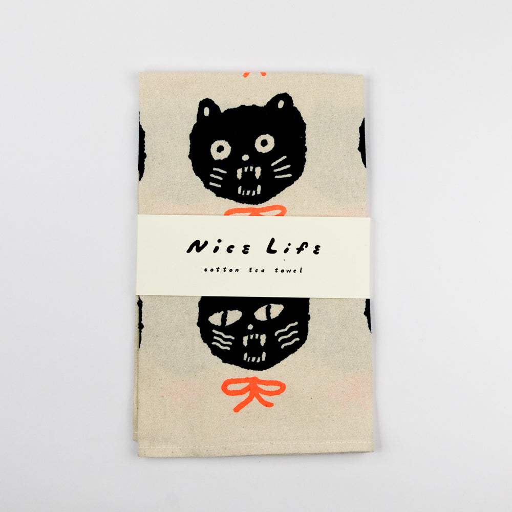 Packaged product with black cat illustration and 'Nice Life' text on a beige background