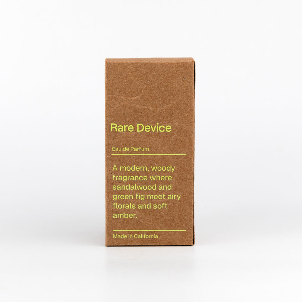 Brown box of 'Rare Device' eau de parfum with yellow text on a white background