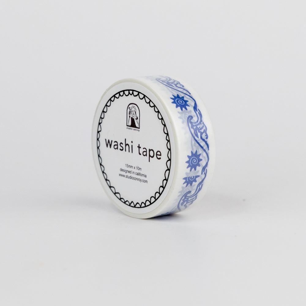 Roll of washi tape with decorative wave design on a white background