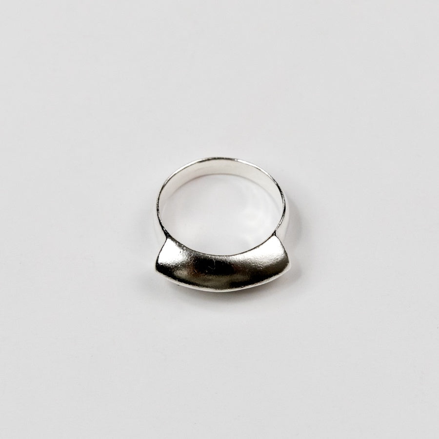 Silver ring on a light gray background